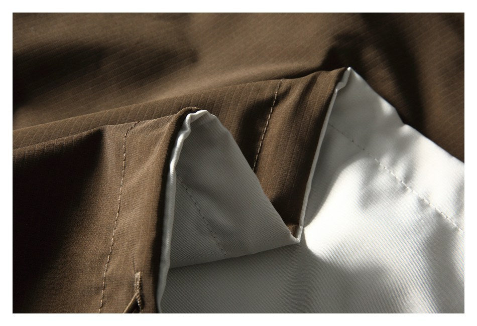 Close-up showing brown outer fabric folded back to reveal pale lining and stitching.
