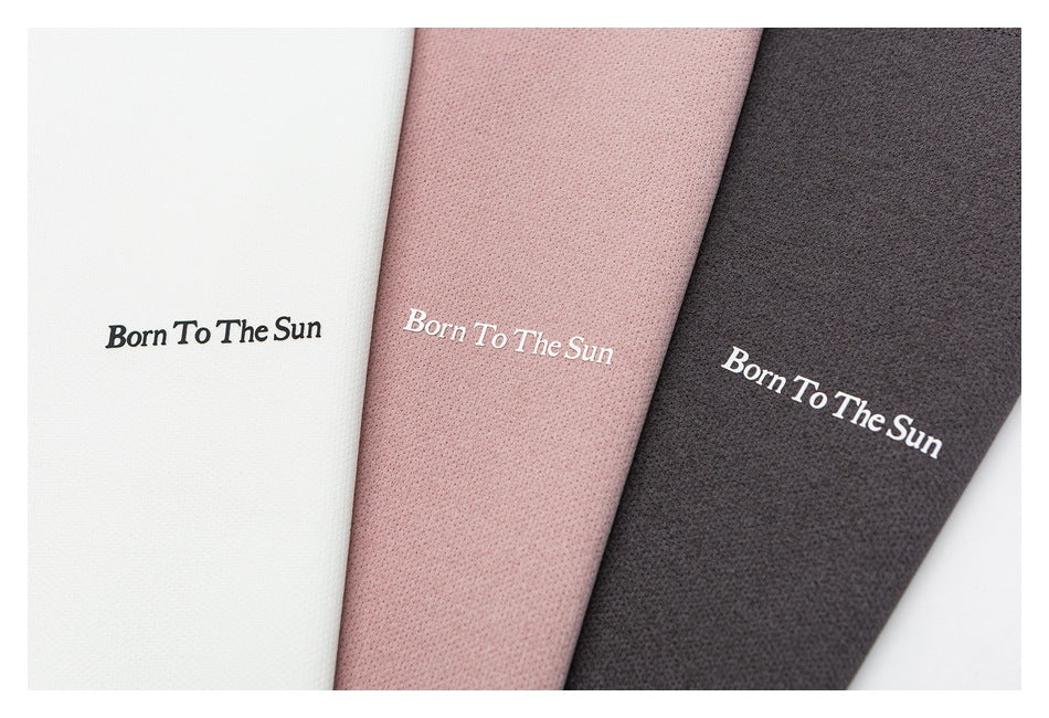 Close-up of three perforated fabric colorways—white, dusty rose, and charcoal—each with “Born To The Sun” lettering.