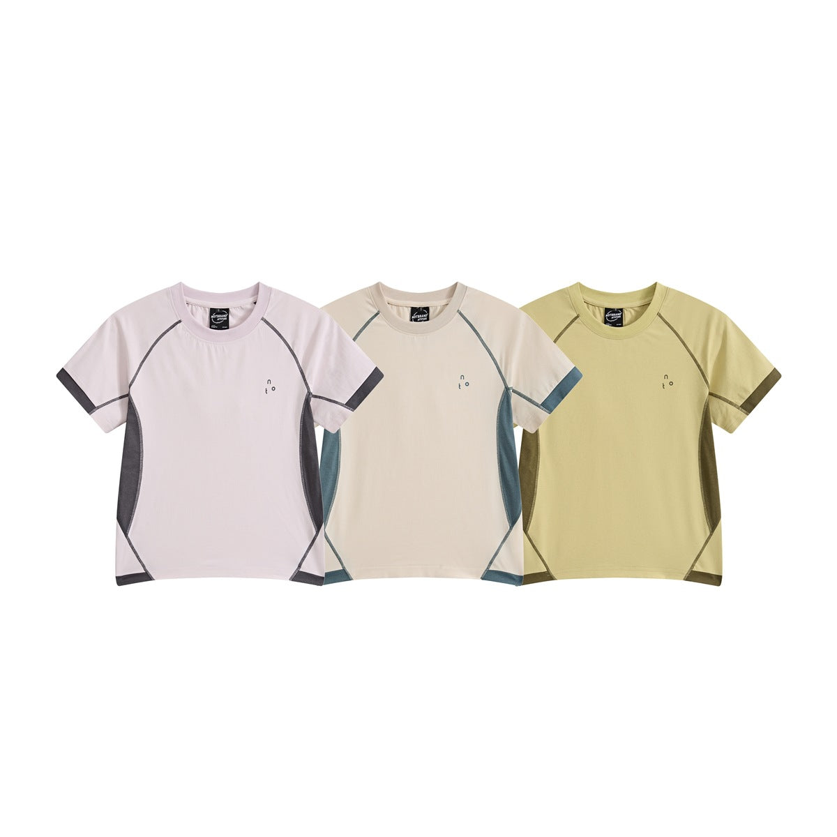 Three short-sleeve raglan T-shirts shown from the front in pale pink, cream and pale yellow with contrast seams.