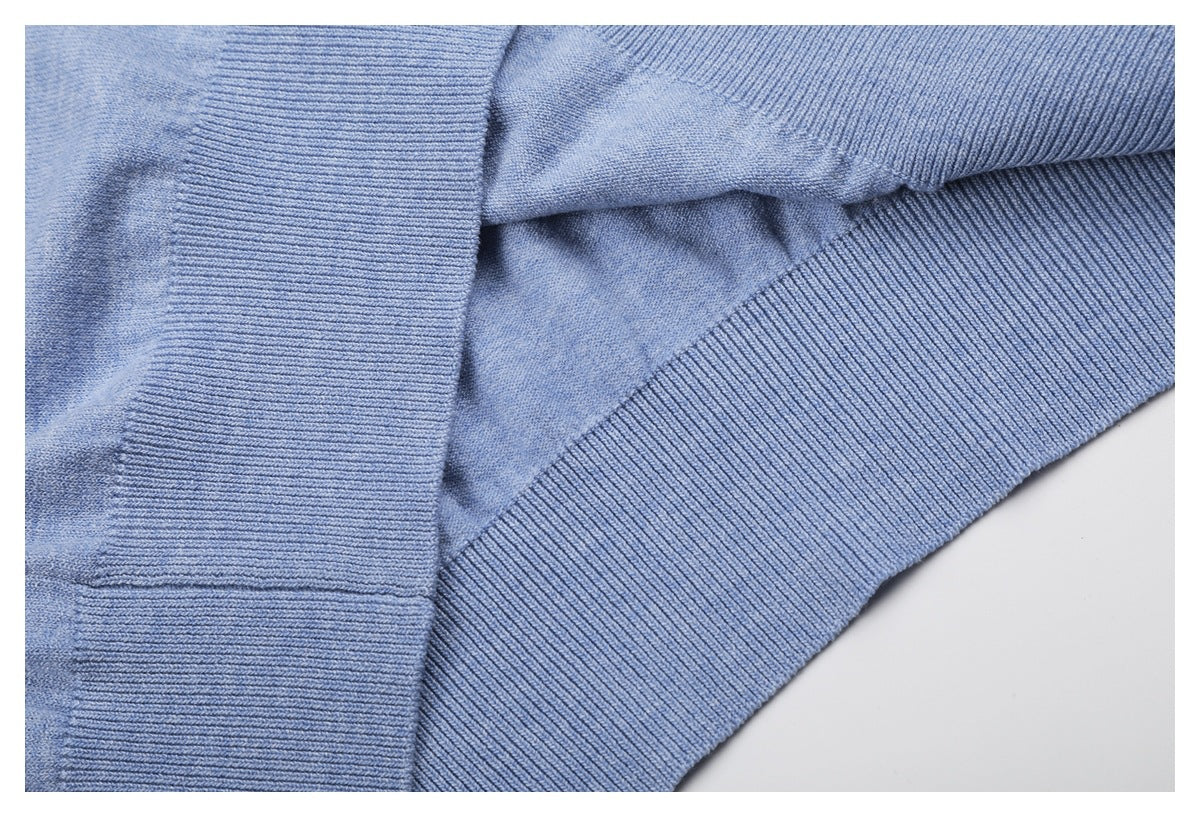 Close-up of overlapping light blue knit sections with ribbed edges.