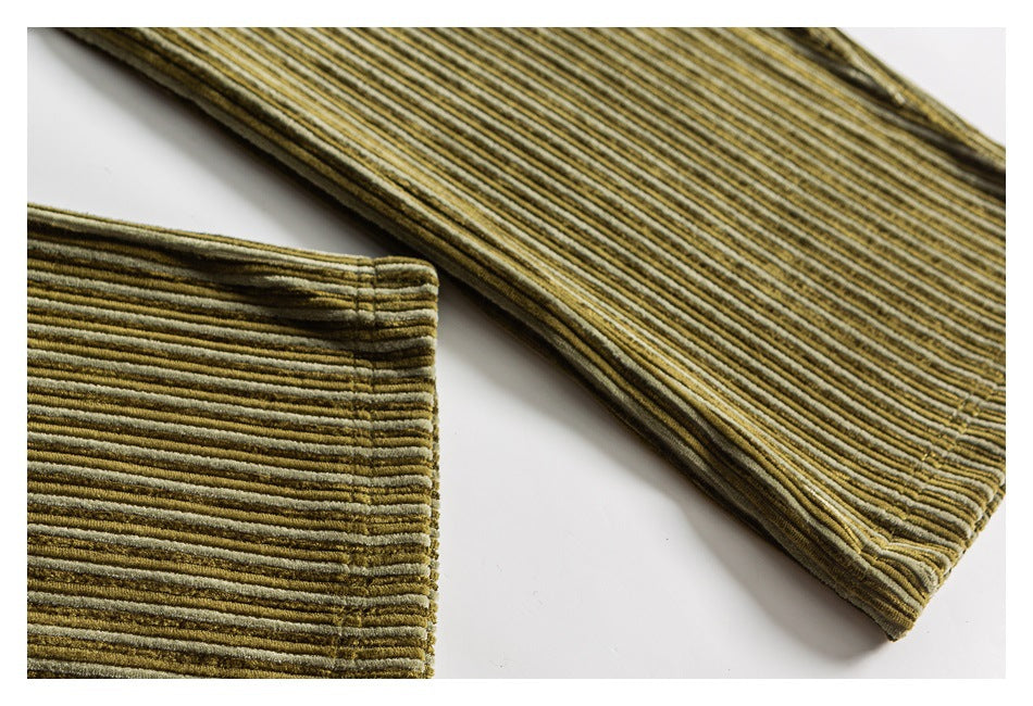Close-up of the striped corduroy pant leg and stitched hem laid flat.