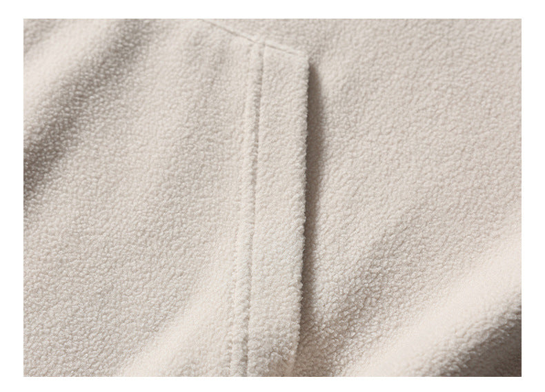 Close-up of a seam in ivory plush fabric.