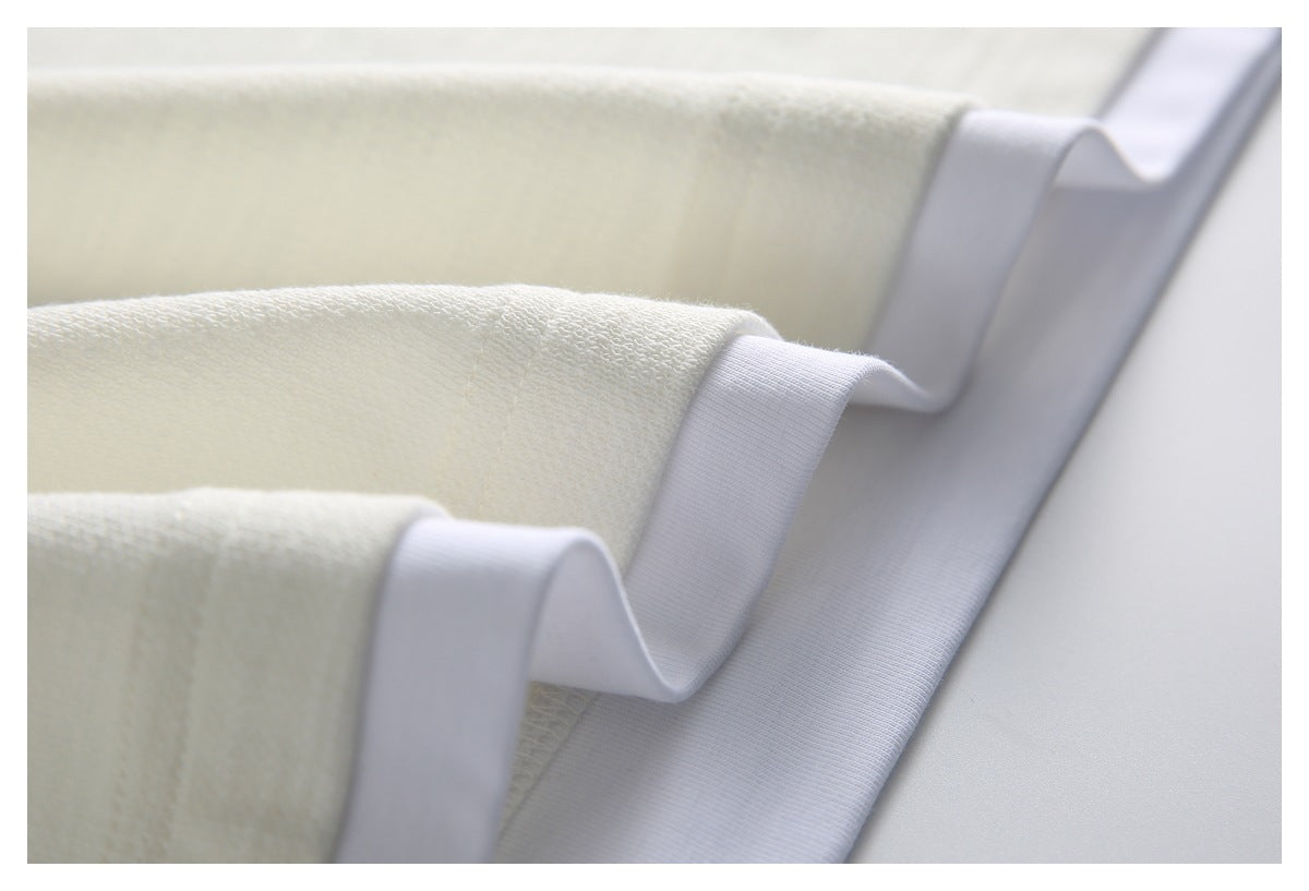 Close-up of the ivory knit garment's folded edge with wide white inner binding.