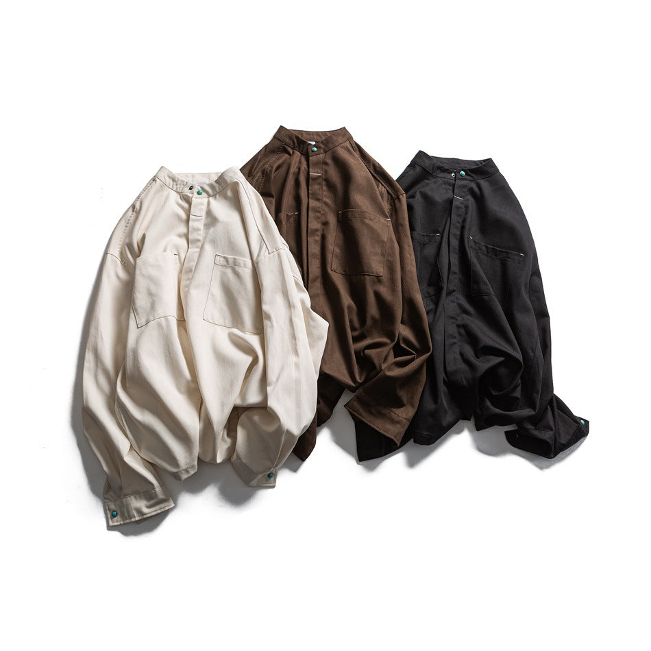 Three long-sleeved shirts in cream, brown, and black, arranged flat to show their stand collars, front plackets, and chest