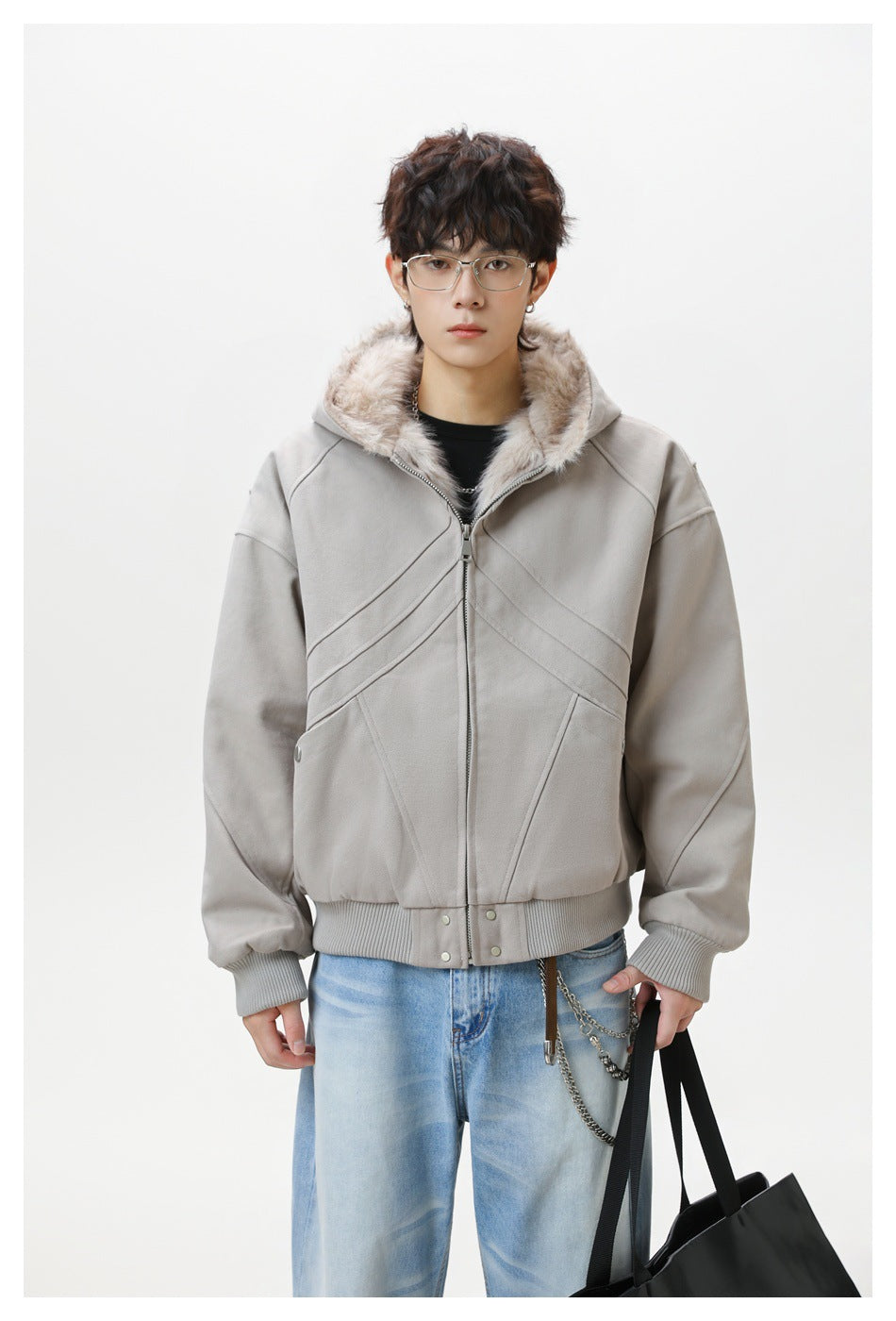 Front view of a model wearing a zipped light gray jacket with a plush-lined hood and ribbed cuffs and hem.