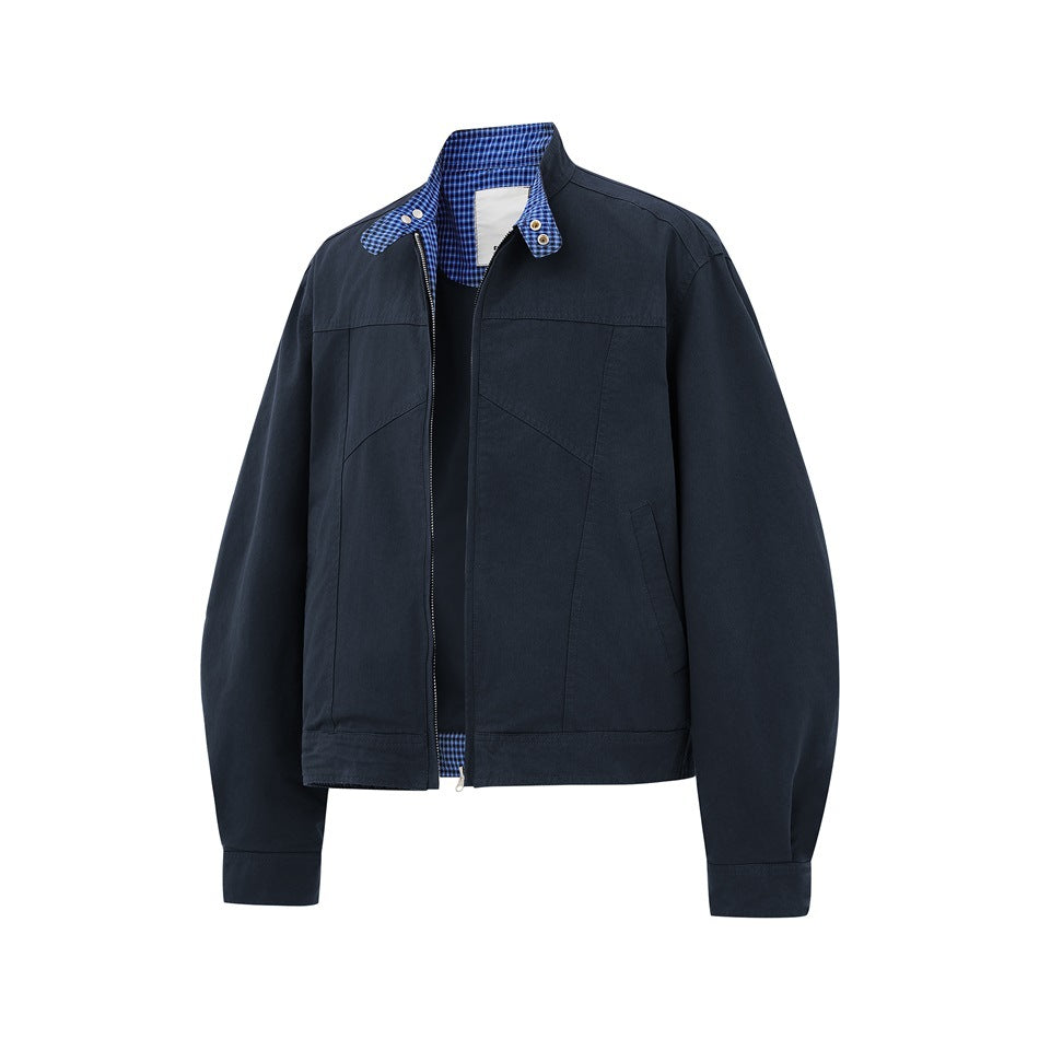 Navy zip jacket partly unzipped, showing blue checked collar interior, snap collar tab and slanted front pocket