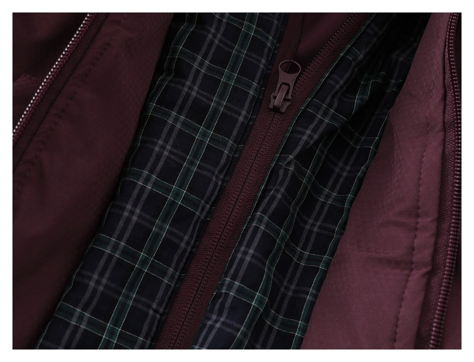 Close-up of the jacket’s dark plaid lining, burgundy zipper, and zipper pull.