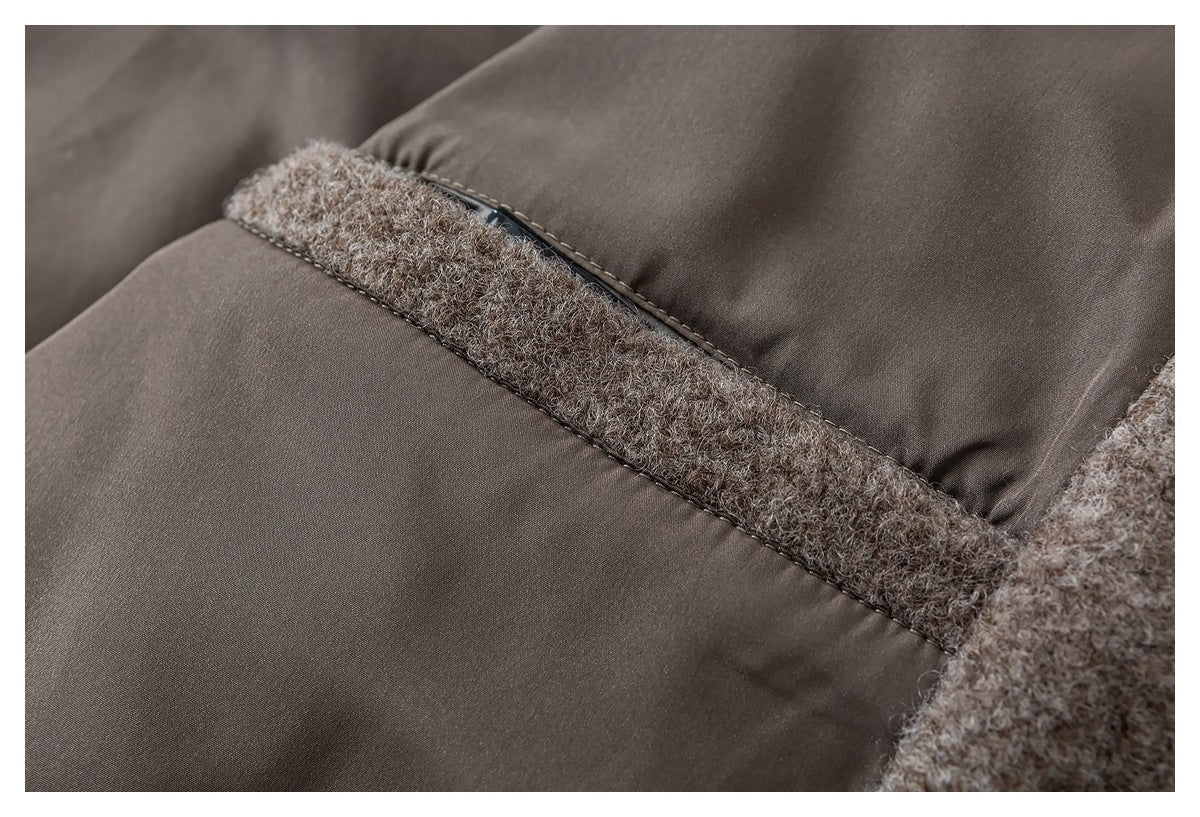 Close-up of a taupe garment interior, showing a smooth lining joined to curly fabric with a stitched seam.