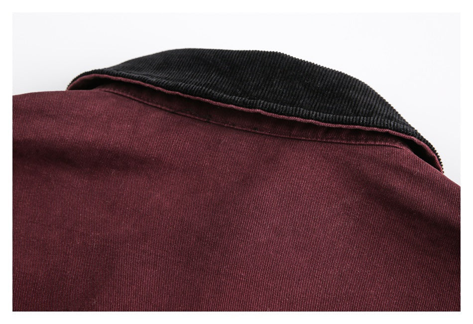 Close-up of a burgundy jacket with a contrasting black corduroy collar.