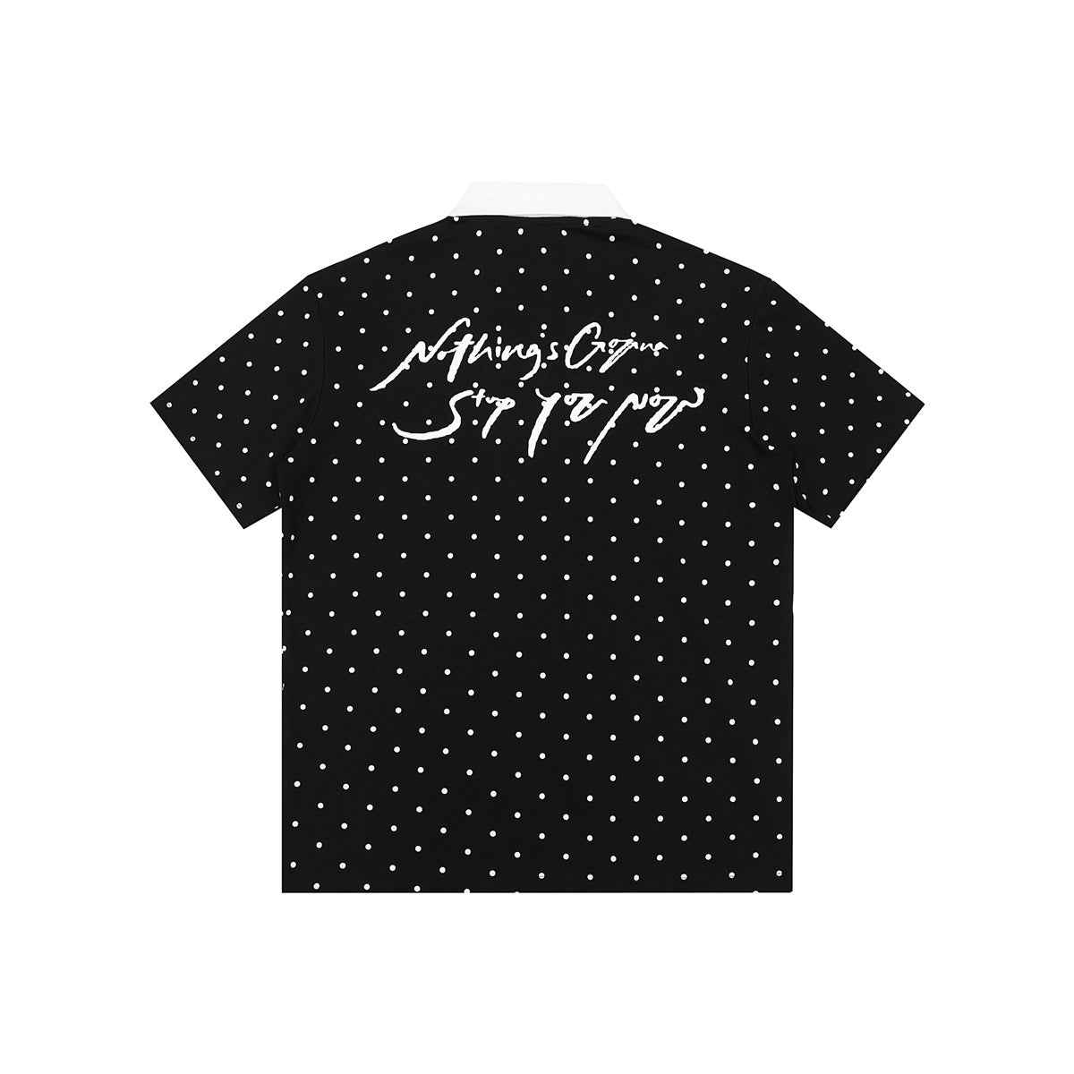 Back of black polo shirt with white polka dots, white collar and white handwritten script graphic on the upper back
