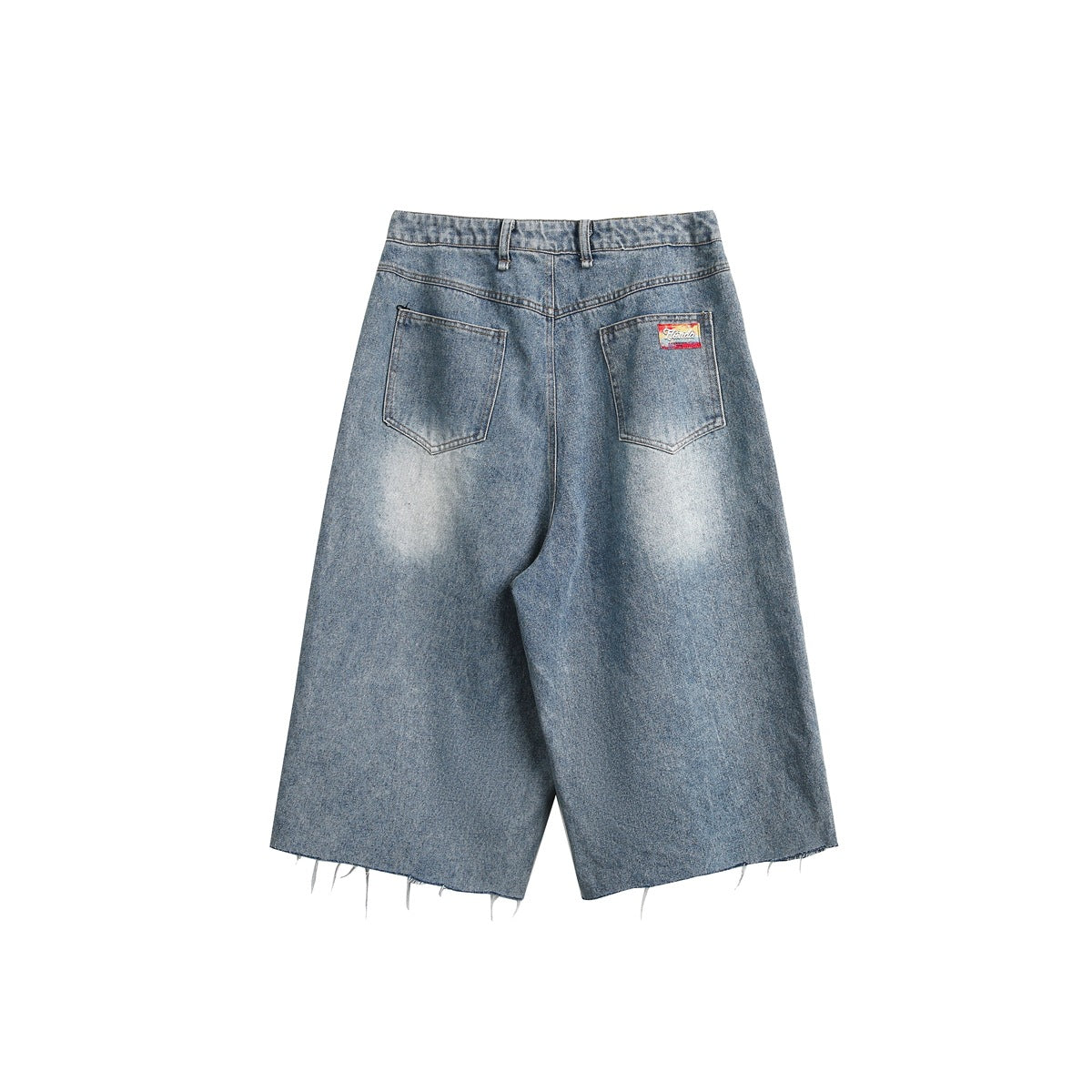 Back view of wide-leg faded blue denim shorts with two pockets, a small label and raw hems.