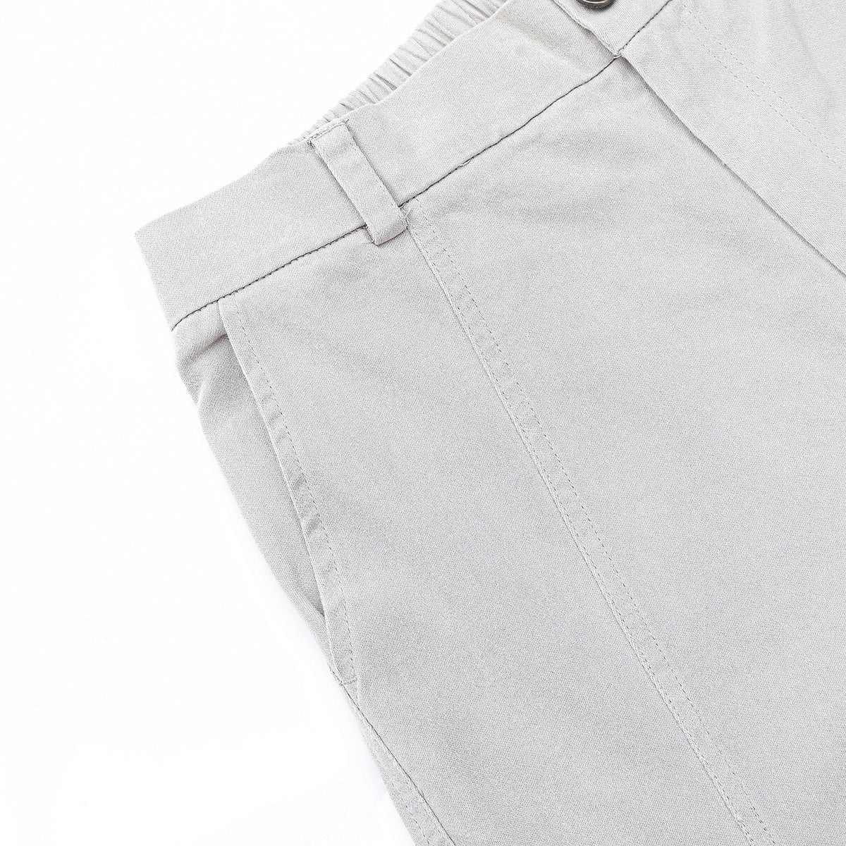 Close-up of light gray trousers showing the waistband, belt loop, button, and stitching.