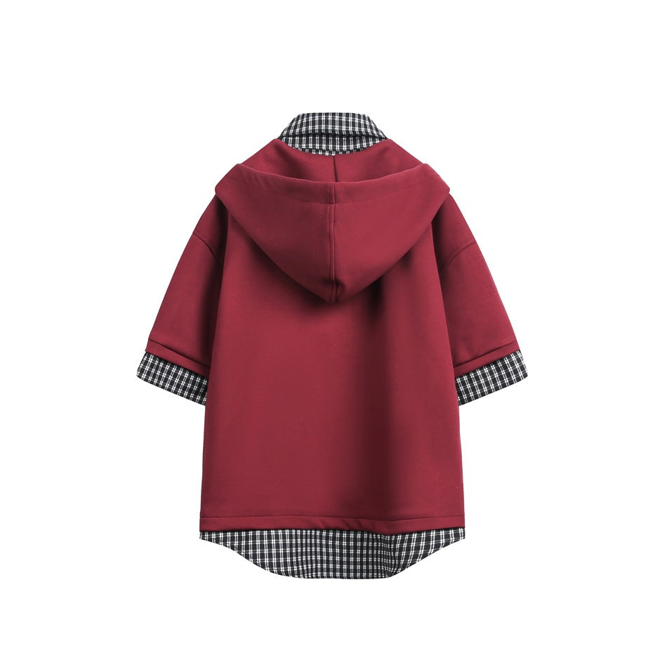 Back view of a burgundy short-sleeve hooded top with black-and-white checked fabric at the collar, cuffs, and curved hem.