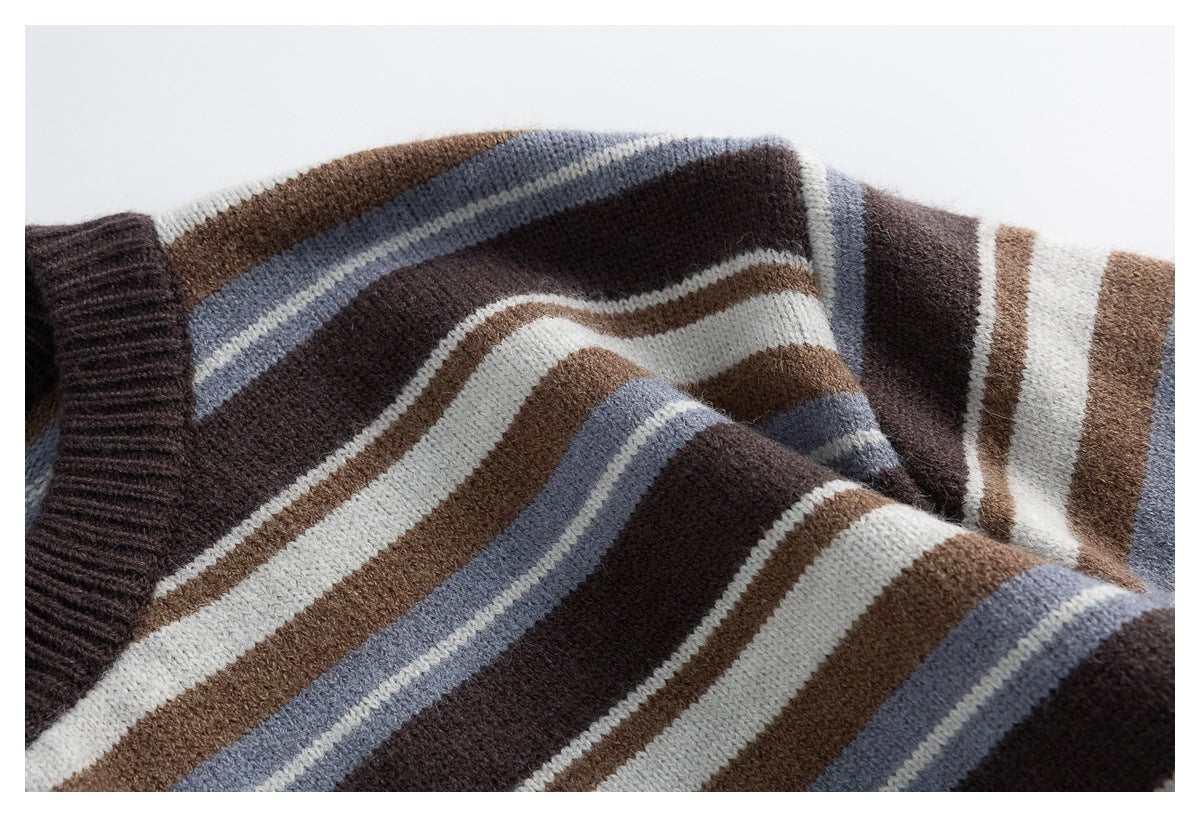 Close-up of the cardigan's cream, brown, blue-gray, and dark brown stripes across the knit fabric and sleeve.