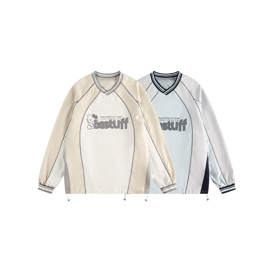 Two matching graphic pullovers displayed side by side: one cream with gray panels and one pale blue-gray with navy panels.
