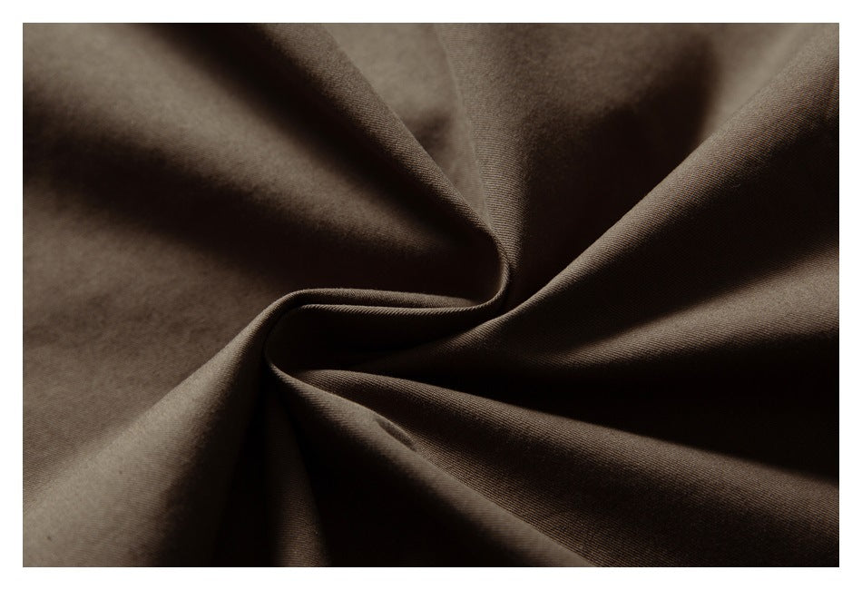 Close-up of smooth dark brown fabric arranged in soft folds.