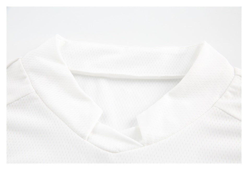 Close-up of a white jersey's short stand collar and perforated fabric.