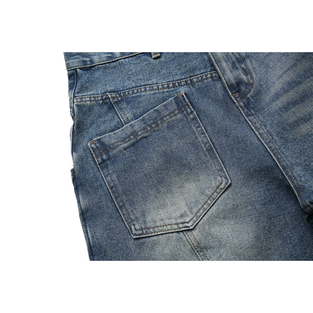 Close-up of blue washed jeans showing a stitched back pocket and surrounding denim seams.