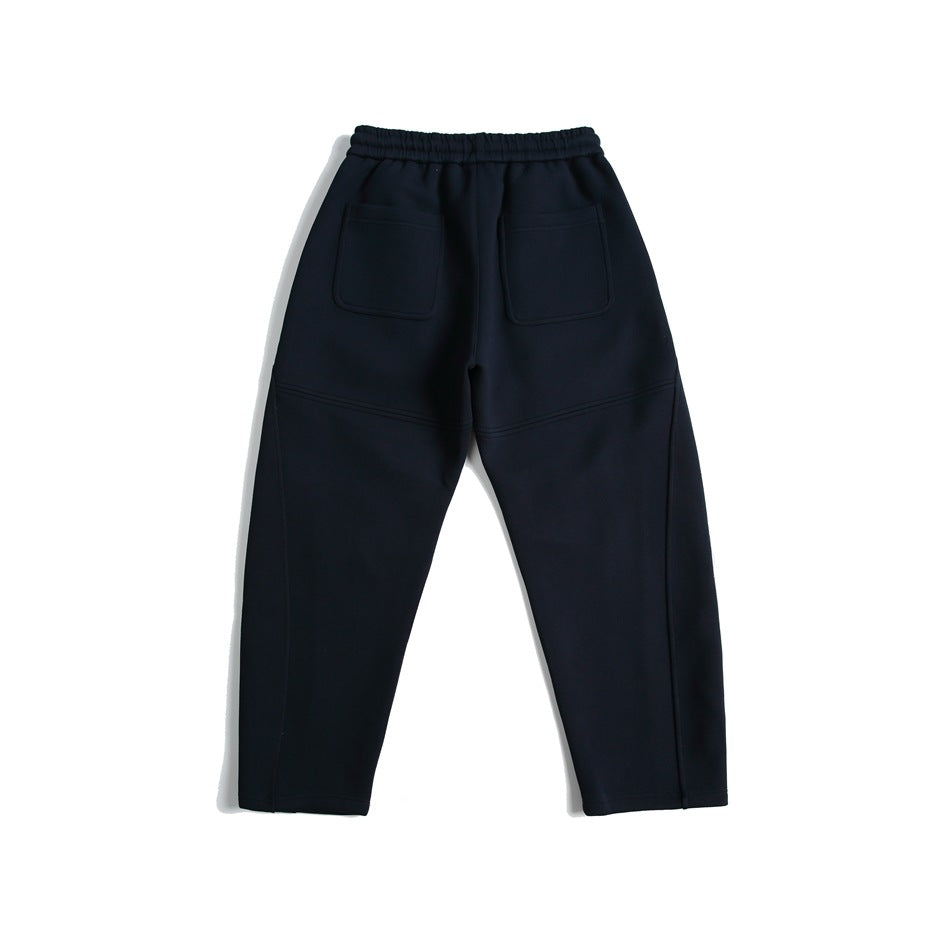 Navy sweatpants back view with two patch pockets, elastic waistband and seam detailing, flat lay