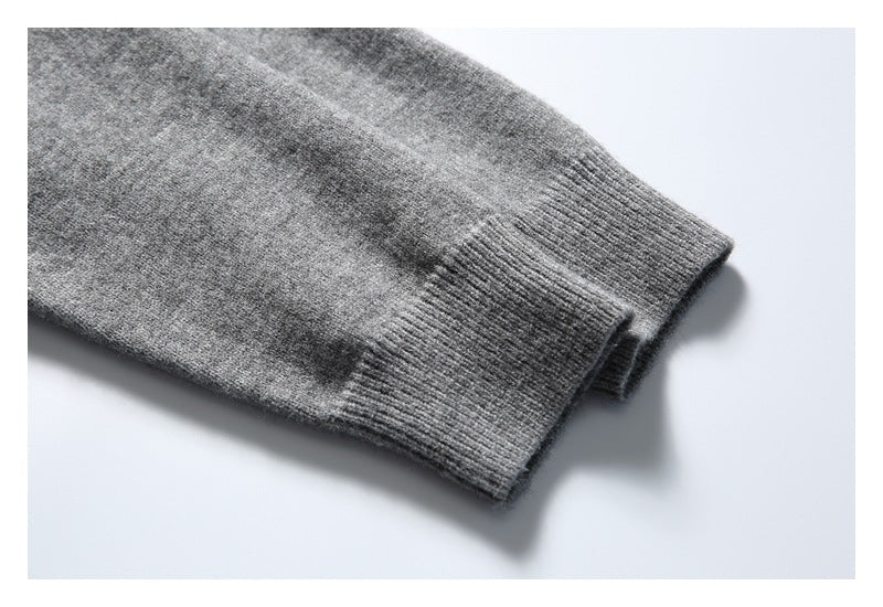 Close-up of a ribbed cuff on a heather gray knit sleeve.