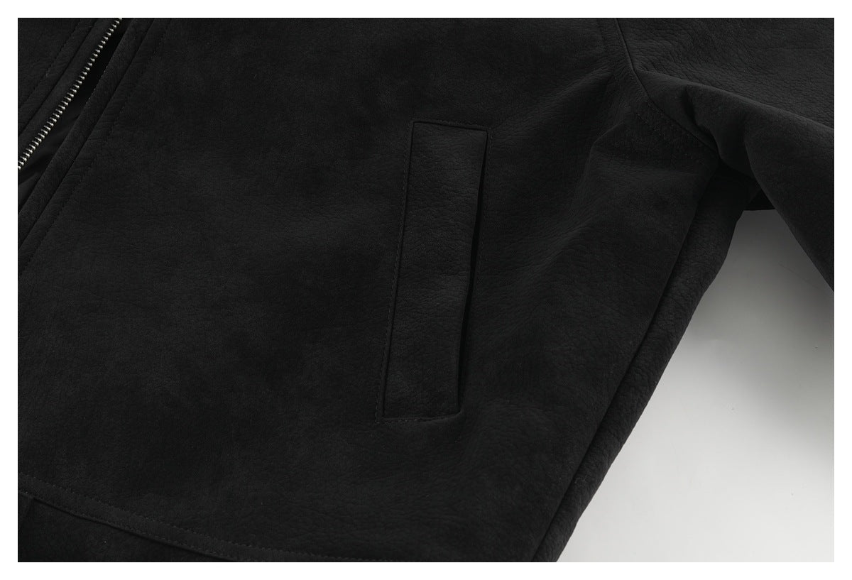 Close-up of a vertical welt pocket on the black jacket, with the front zipper partly visible.