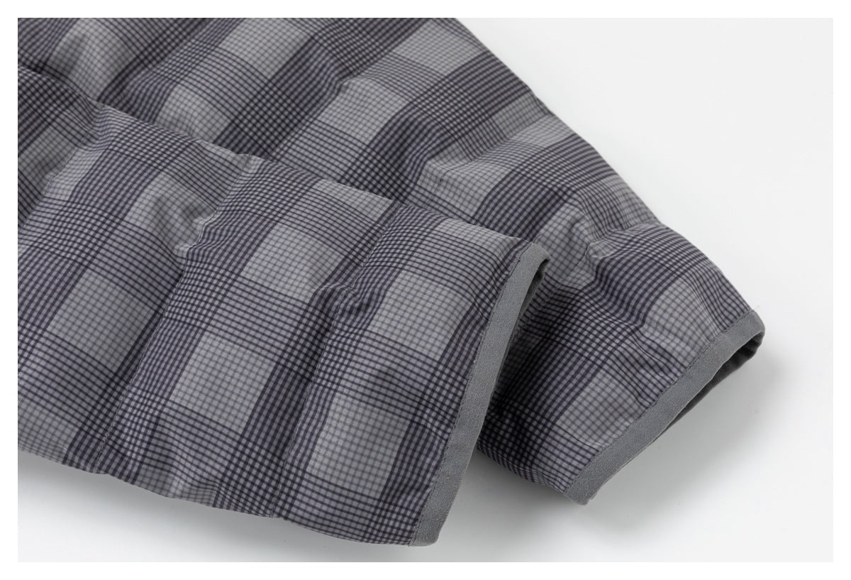 Close-up of gray and black checked fabric showing a folded edge with solid gray binding.
