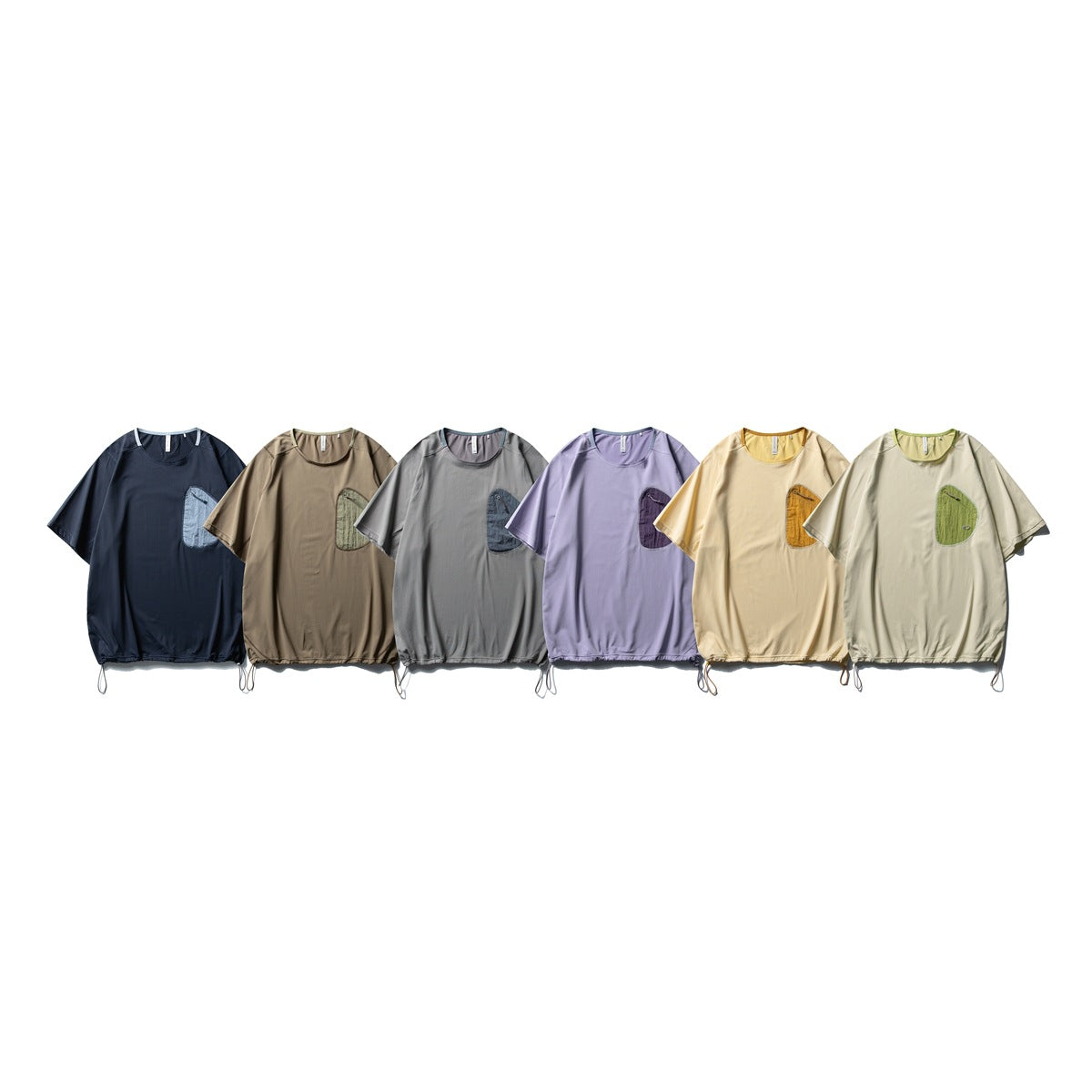 Six short-sleeve tops displayed together in navy, brown, gray, lavender, pale yellow, and light sage, each with a chest