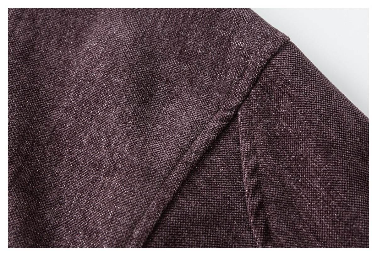 Close-up of dark plum-brown garment fabric showing a diagonal stitched seam and textured weave.