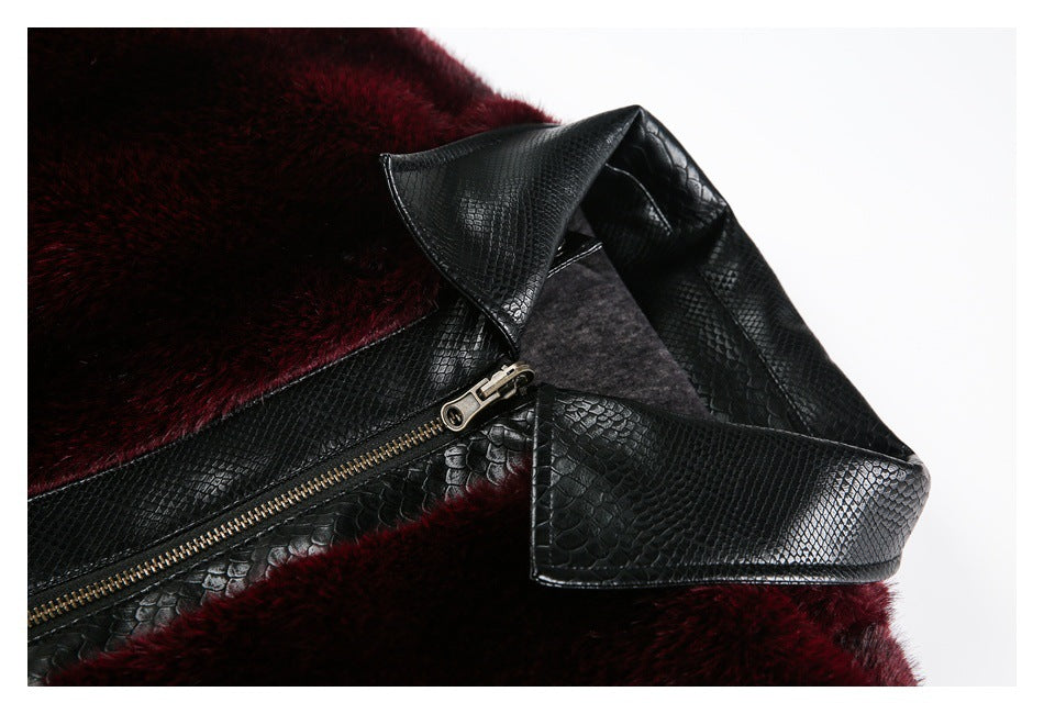 Close-up of the jacket’s black textured collar and zipper against burgundy plush fabric.