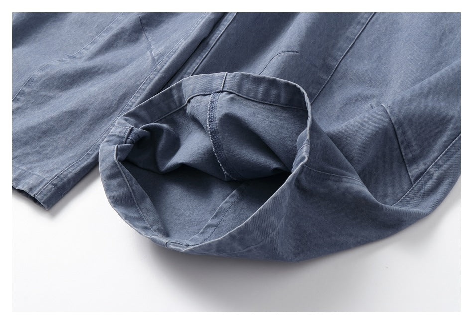 Close-up showing the inside seam and construction of blue-gray trousers.