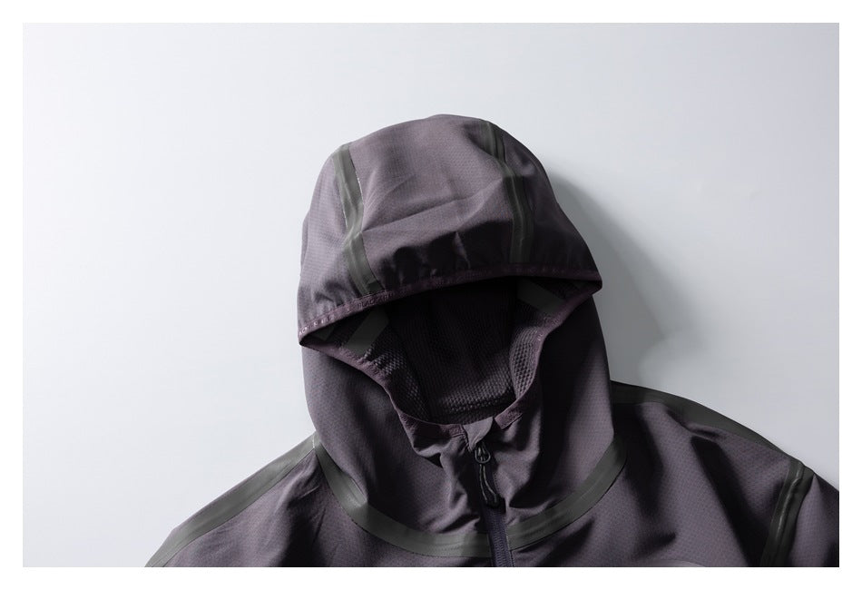 Close-up of a dark charcoal-purple jacket hood with mesh lining and dark seam-tape accents.