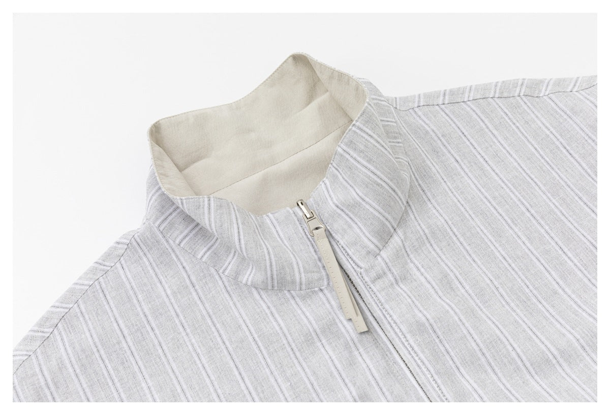 Close-up of the jacket's striped stand collar, pale lining, and front zipper.