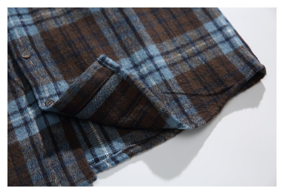 Close-up of the plaid shirt's lower edge, with a folded section showing the reverse side of the fabric.