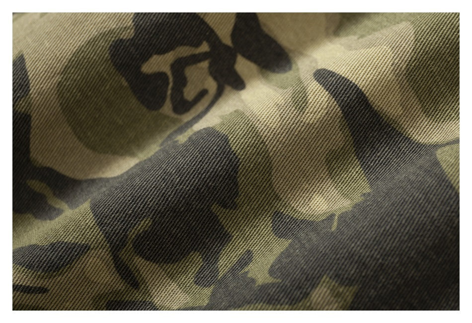 Close-up of olive, tan, and dark camouflage-patterned fabric.