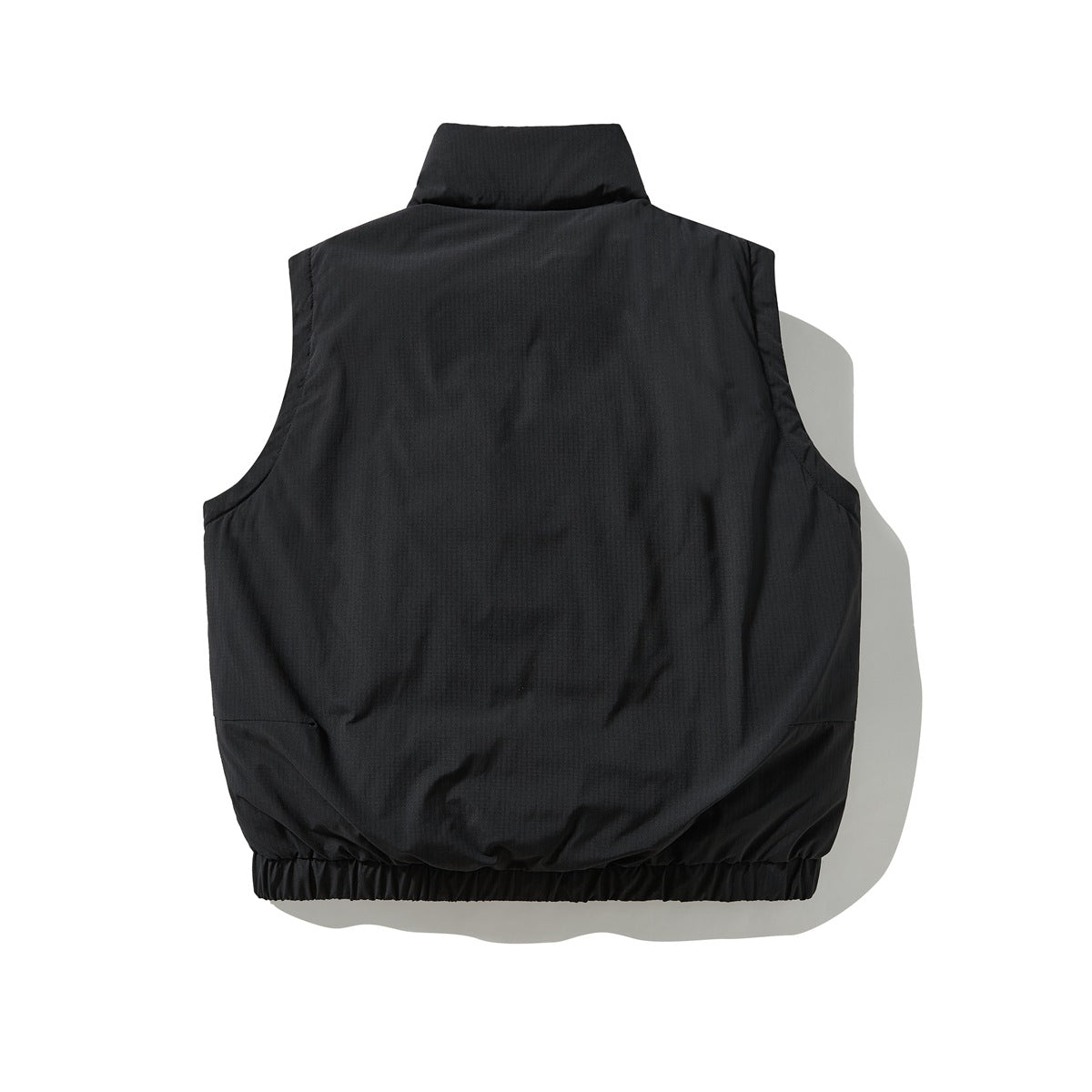 Back view of a black sleeveless vest with a stand collar and gathered hem.