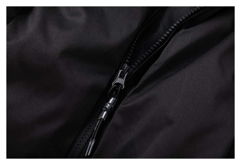 Close-up of the black jacket's front zipper and corded zipper pull.