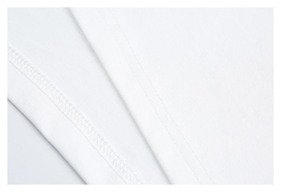 Close-up of the white T-shirt's stitching and overlocked seam.