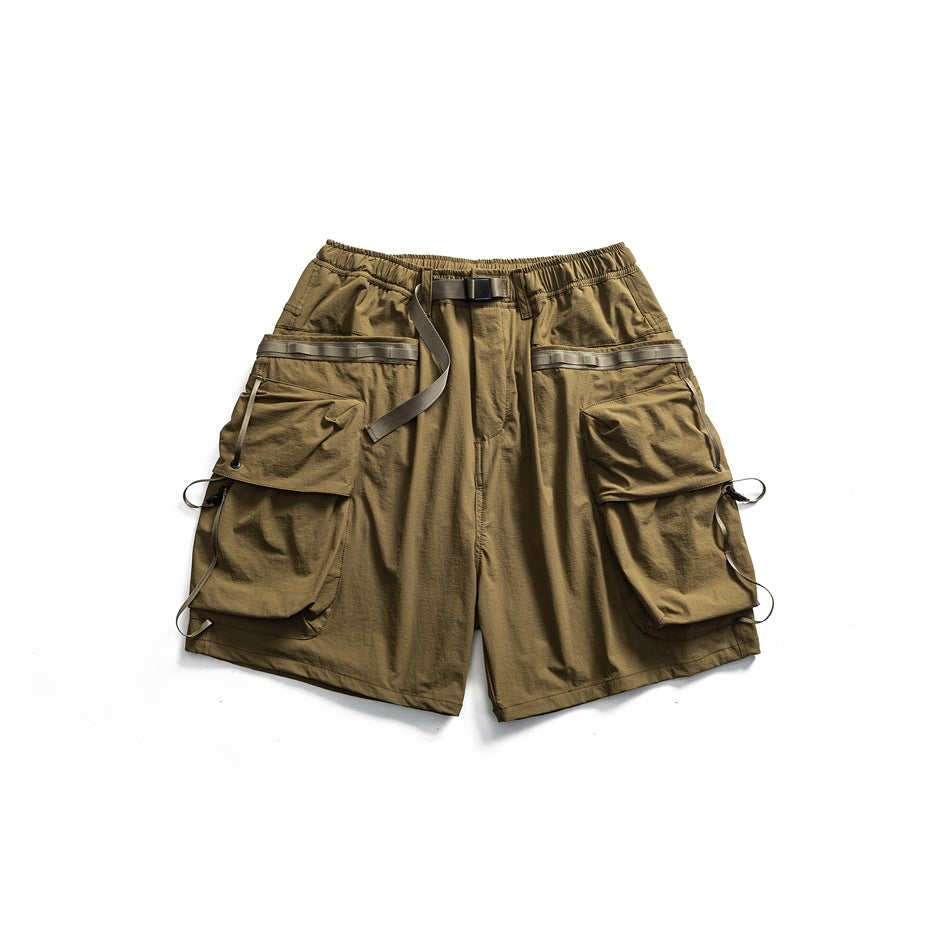Khaki olive-tan cargo shorts flat lay with elastic waist, webbing belt and large flap pockets