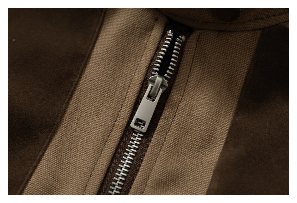Close-up of the jacket's silver metal zipper between tan and dark brown panels.