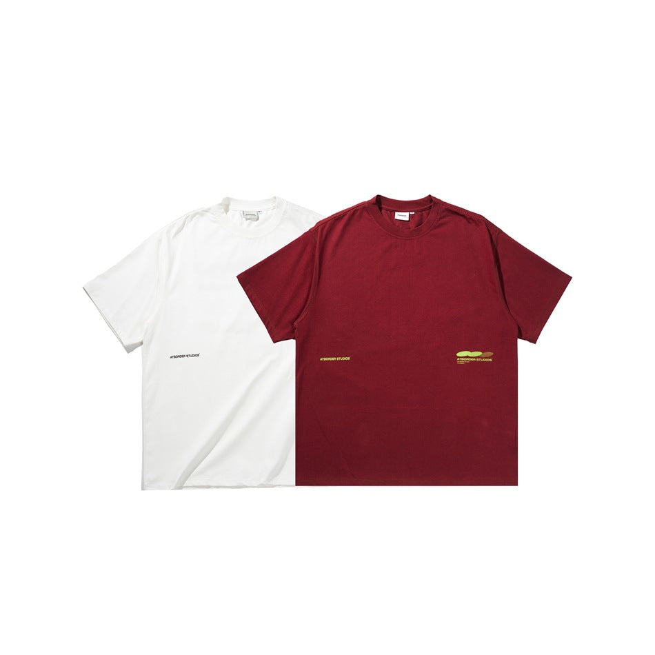 White and burgundy crew-neck T-shirts shown side by side, each with a small chest logo.