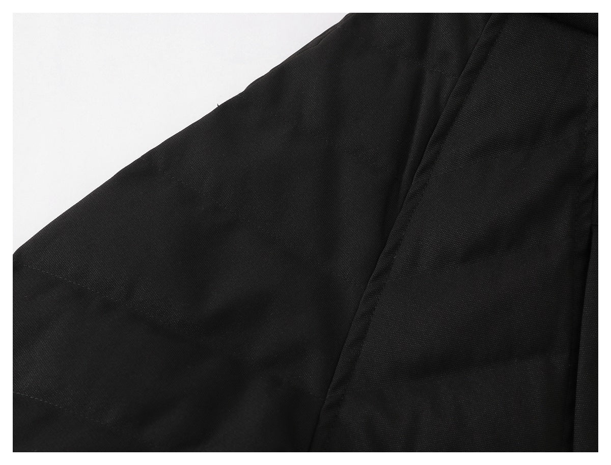 Close-up of black garment fabric with a stitched seam and panel.