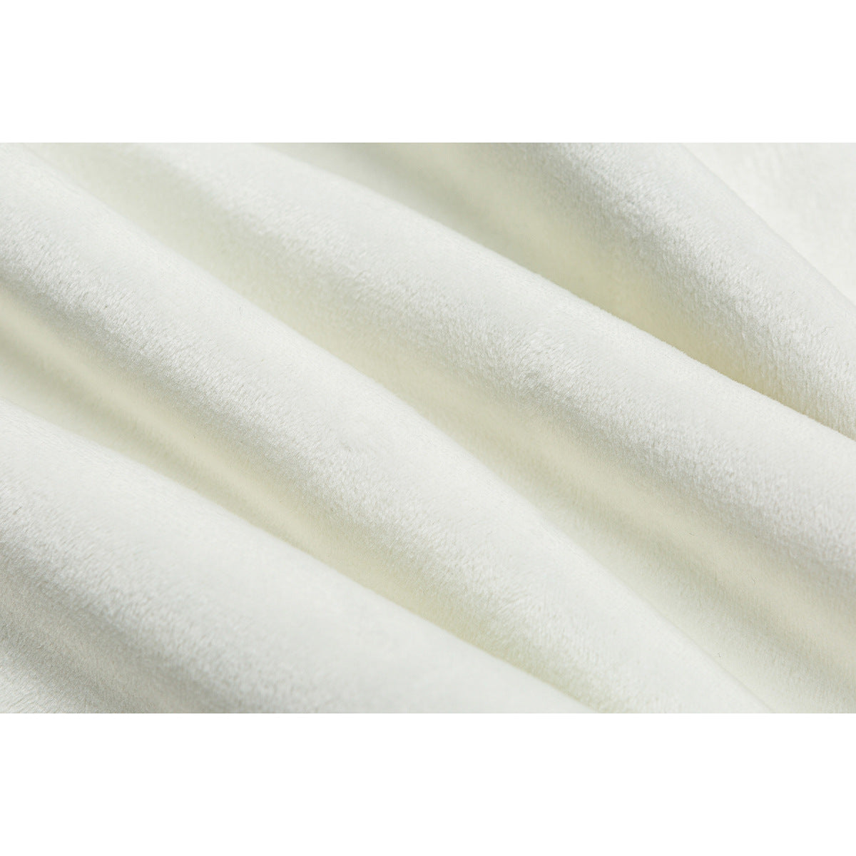 Macro view of softly textured ivory fabric arranged in diagonal folds.