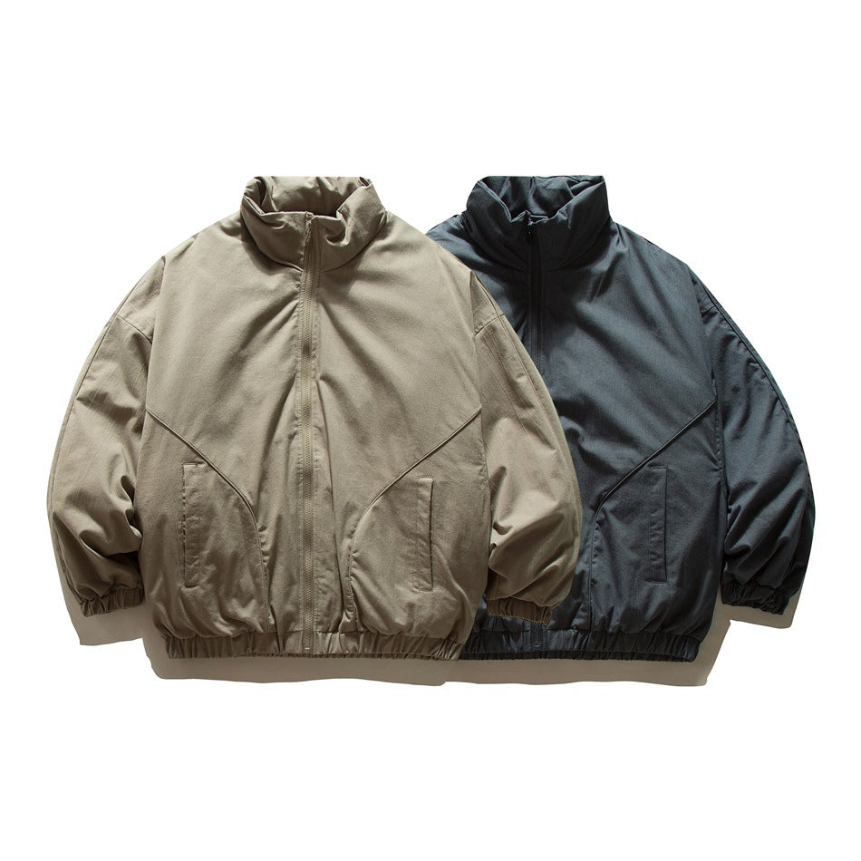 Front view of two zip-front jackets with stand collars and elastic hems, in beige and dark blue-gray.