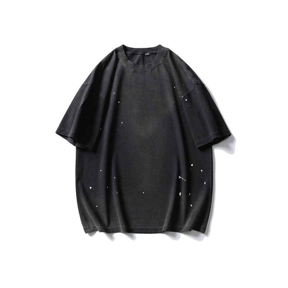 Black washed short-sleeve crew-neck T-shirt with white paint splatter, flat front view