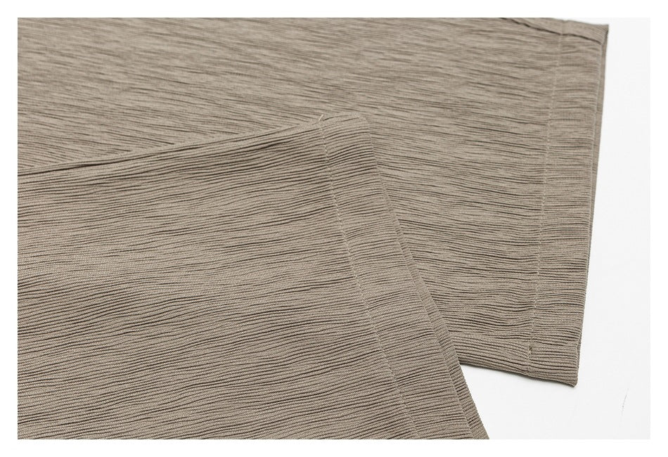 Close-up of the ribbed taupe pant legs and stitched hems.