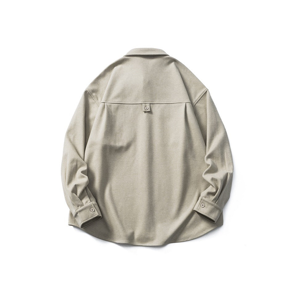 Back view of beige long-sleeve shirt with back yoke seam, small button tab and button cuffs, flat lay