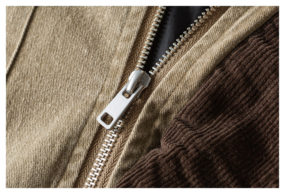 Close-up of a metal zipper on a tan garment, beside a dark brown ribbed panel.
