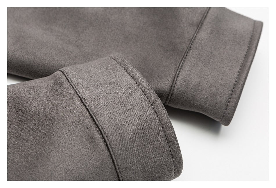 Close-up of charcoal gray garment sleeves with wide stitched cuffs.