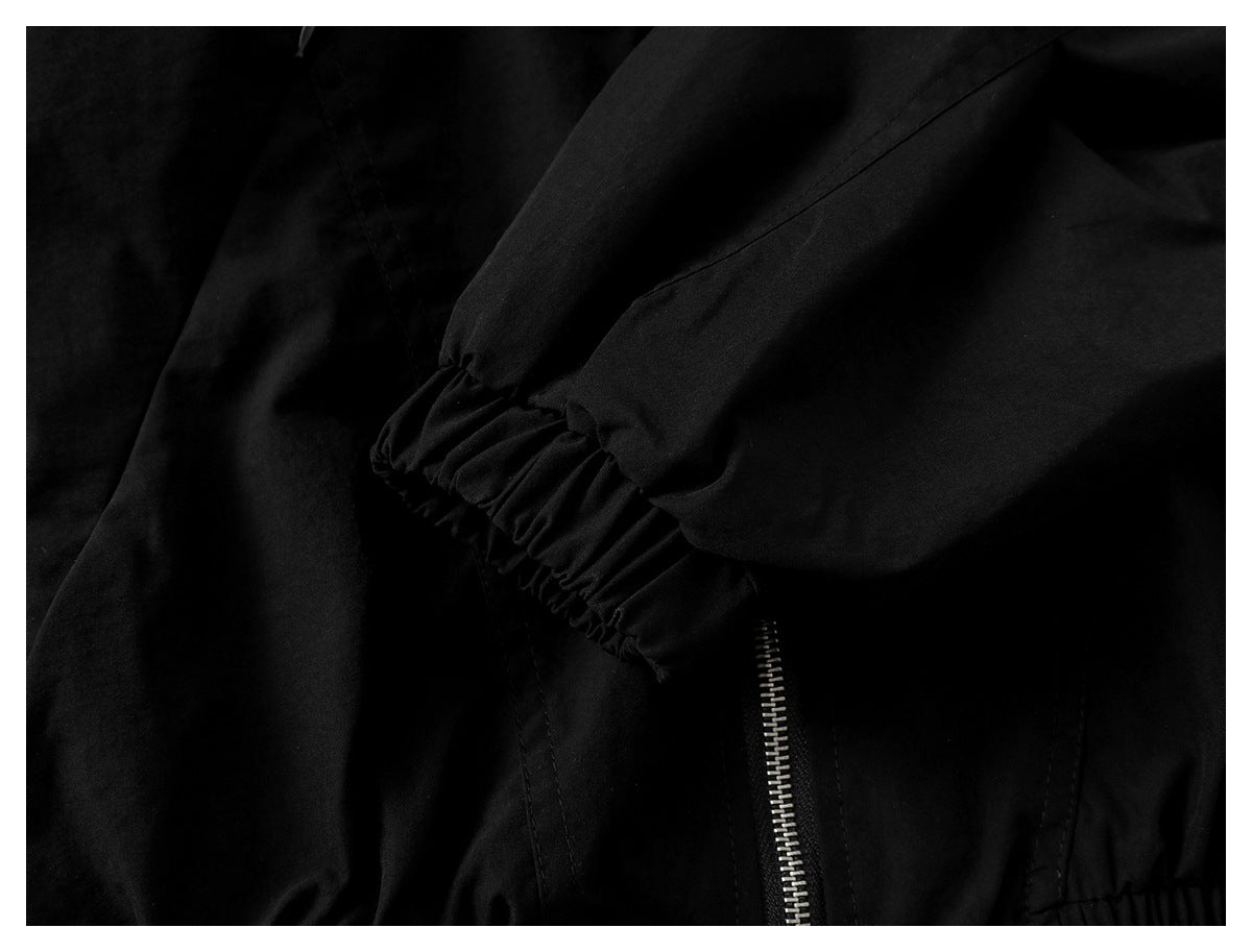 Close-up of the black jacket's sleeve with a gathered elastic cuff.