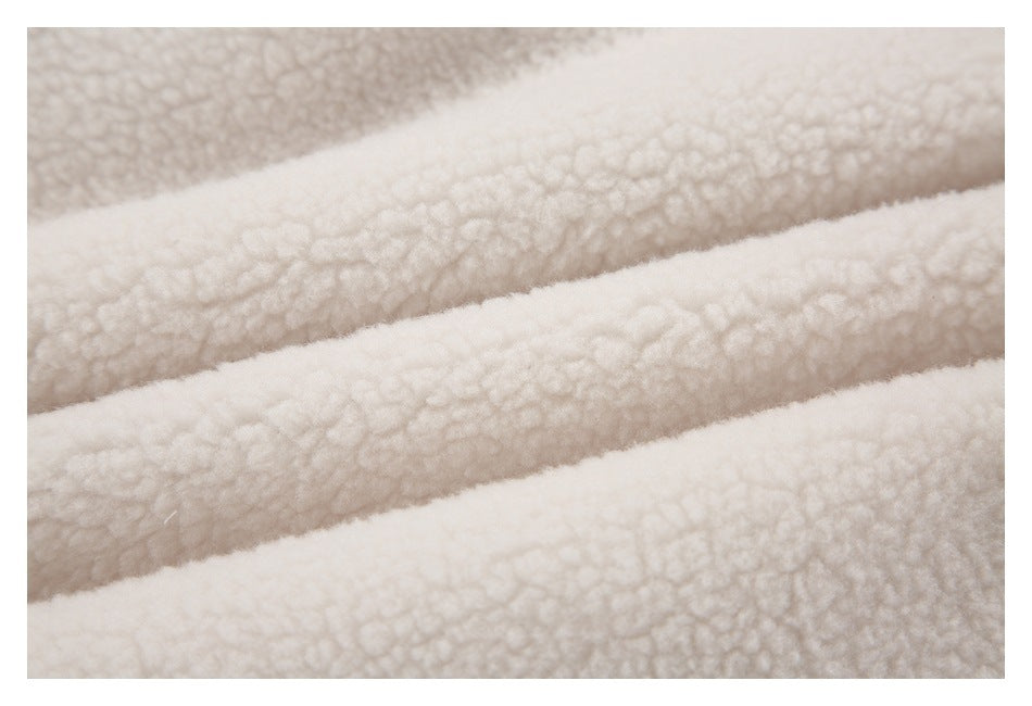 Close-up showing the cream sherpa jacket fabric's plush, curly texture.